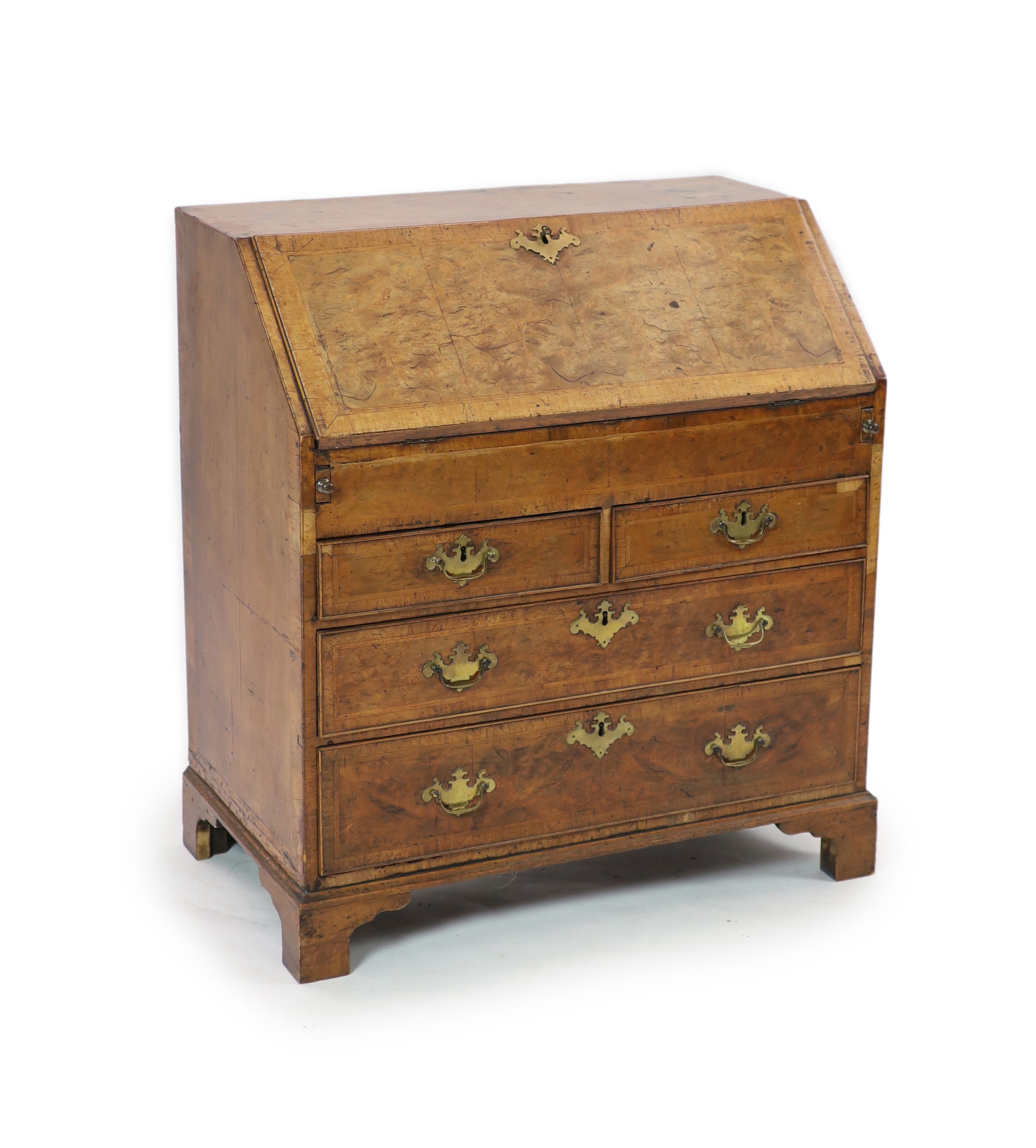 A George II walnut bureau H 101cm. W 92cm. D 53cm.